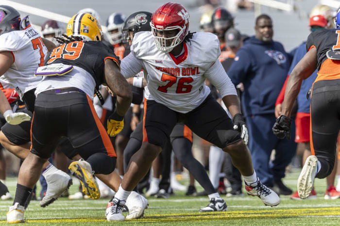 Feb 1, 2024; Mobile, AL, USA; American offensive lineman Patrick Paul of Houston (76) faces off against American defensive lineman Jordan Jefferson of LSU (99) during practice for the American team at Hancock Whitney Stadium. Mandatory Credit: Vasha Hunt-USA TODAY Sports  